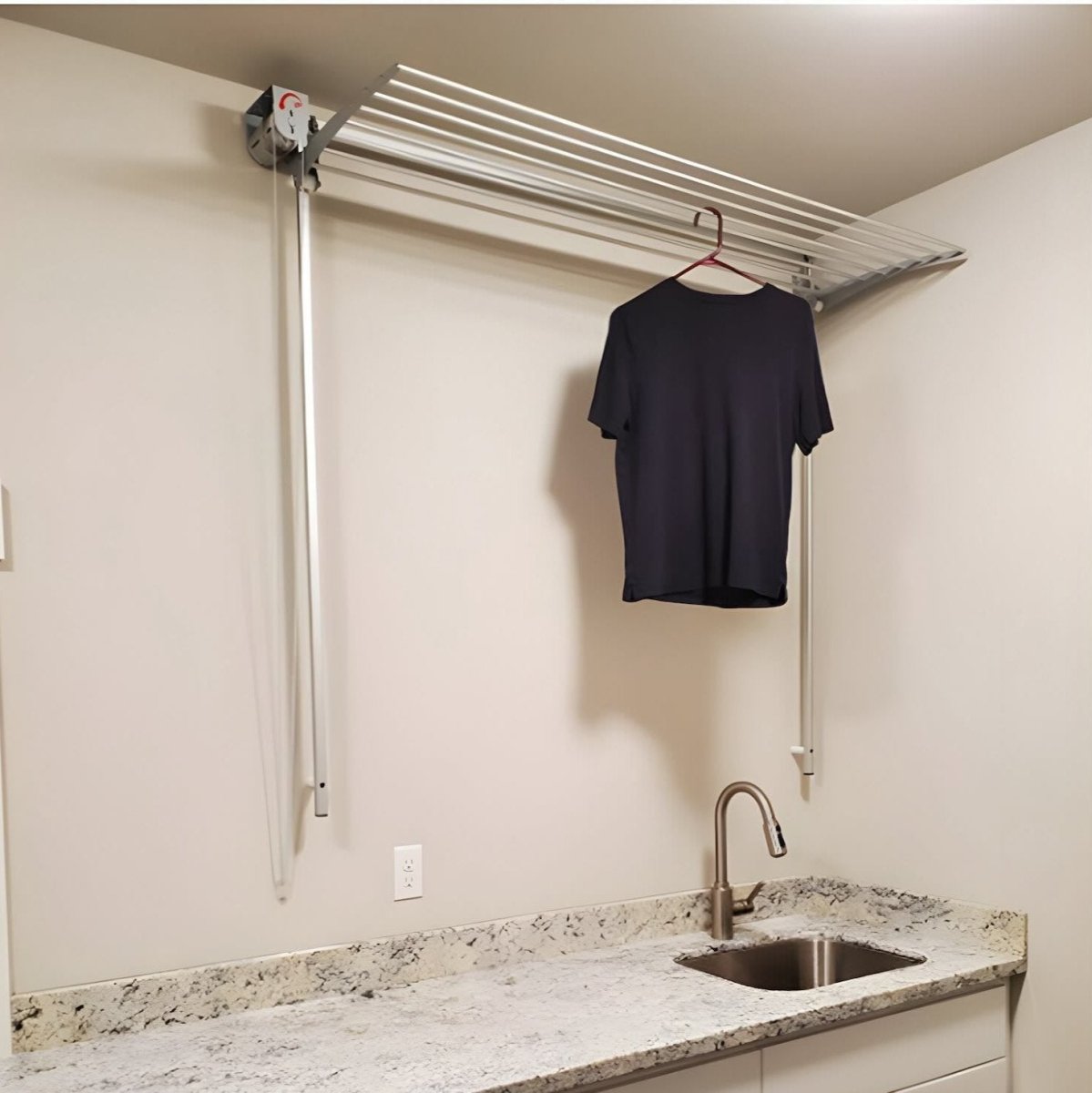 FoxyDry Wall installed in a laundry area or laundry room drying a shirt over a sink