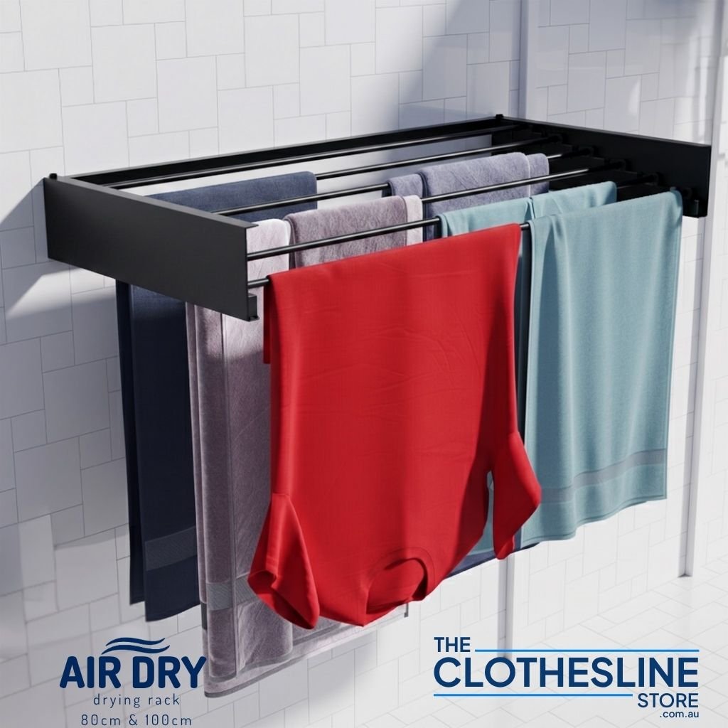 Wall-mounted Air Dry 100 clothes airer with laundry hanging on a tiled wall - colour black.
