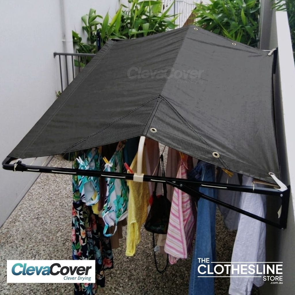 Clothesline installed on a rendered wall with washing hung on the lines.  Cover fully extended.