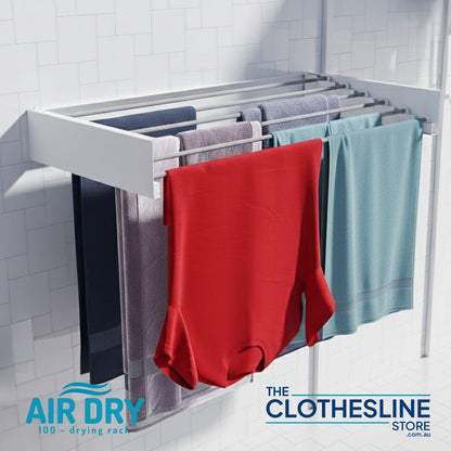 Wall-mounted Air Dry 100 clothes airer with laundry hanging on a tiled wall.