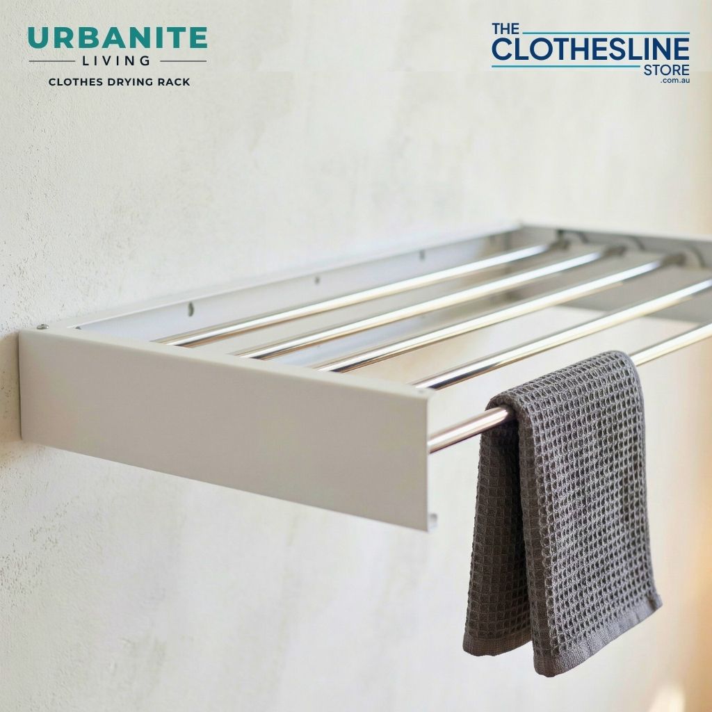 Urbanite Living Drying Rack installed on a wall with a tea towel hung over the line.